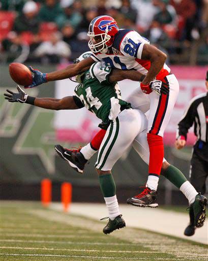 Darrelle Revis fights the Bills' Terrell Owens for the ball